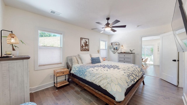 bedroom with ceiling fan and dark hardwood / wood-style flooring