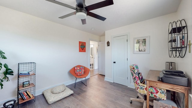 office area featuring dark wood-type flooring and ceiling fan