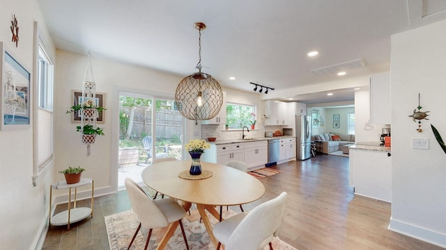 dining room with sink and hardwood / wood-style floors