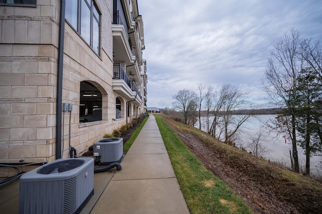 exterior space with a water view and central air condition unit