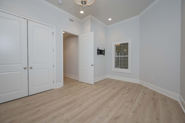 unfurnished bedroom featuring ornamental molding, light hardwood / wood-style floors, and a closet