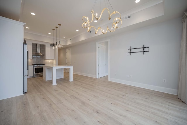 unfurnished living room featuring crown molding and light wood-type flooring