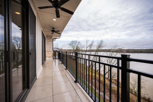 balcony featuring ceiling fan and a water view