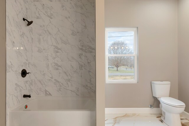 full bathroom featuring marble finish floor, a healthy amount of sunlight, toilet, and baseboards