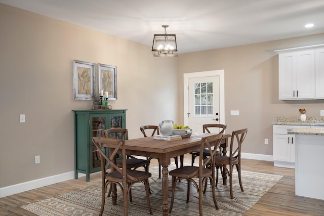 dining space featuring recessed lighting, baseboards, a chandelier, and light wood-type flooring