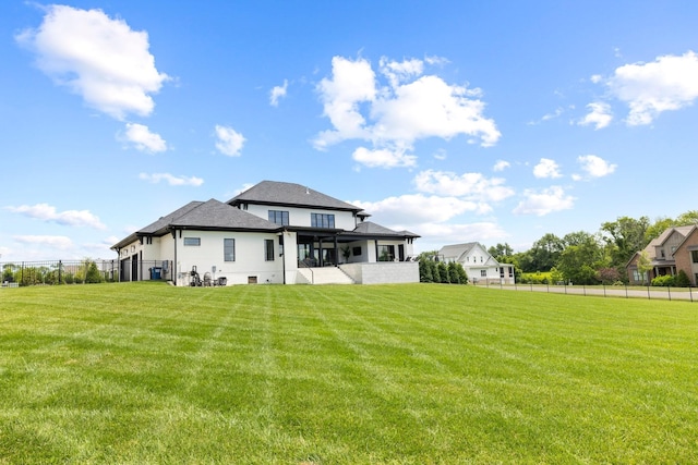 rear view of house with a lawn