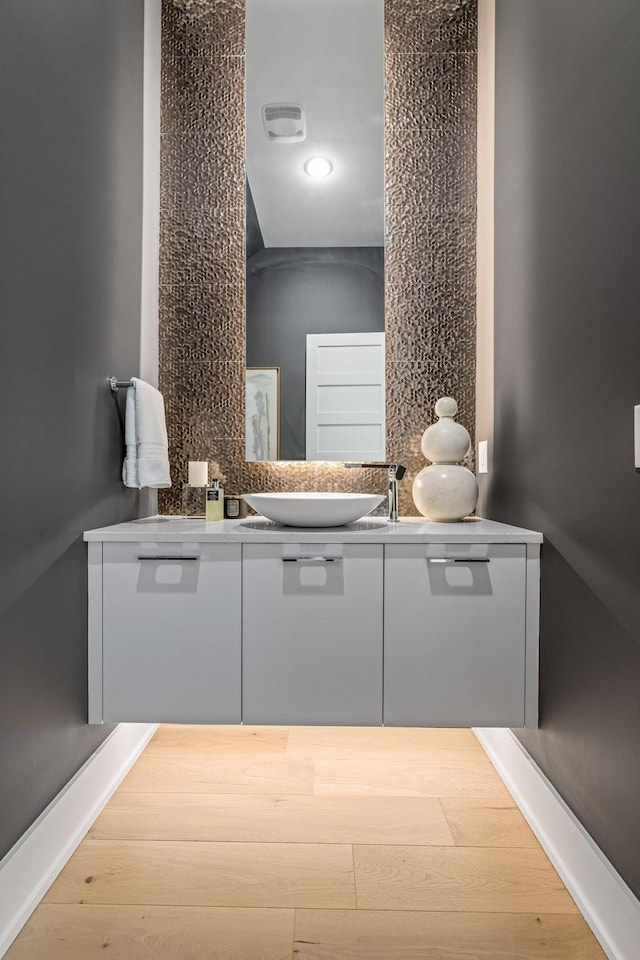 bathroom with hardwood / wood-style flooring and vanity