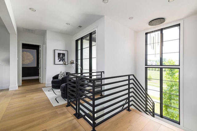 stairs featuring hardwood / wood-style floors