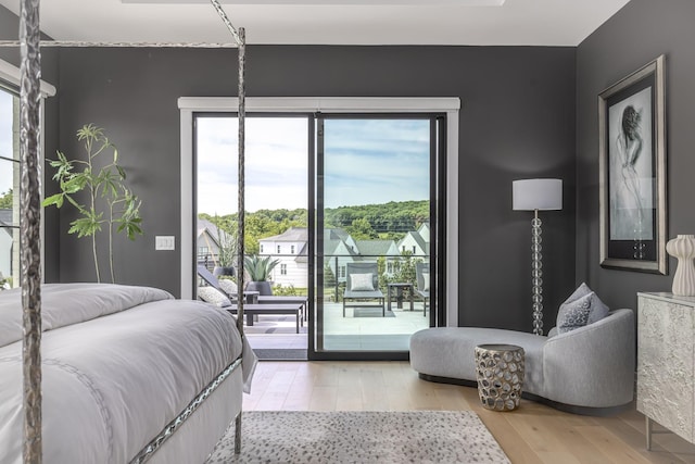 bedroom featuring access to exterior and light hardwood / wood-style floors