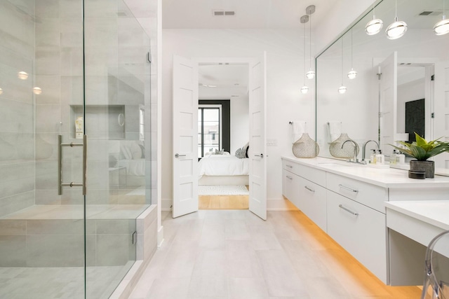 bathroom with vanity and a shower with shower door