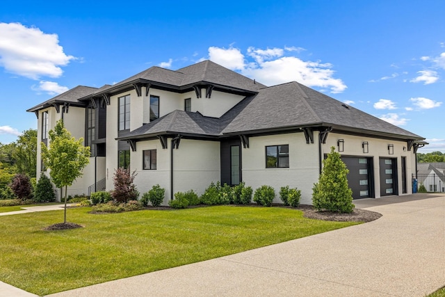 view of front facade featuring a garage and a front lawn