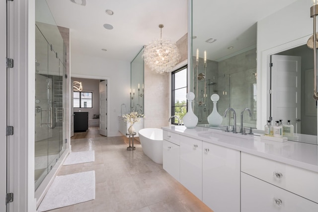 bathroom with vanity, independent shower and bath, and a healthy amount of sunlight