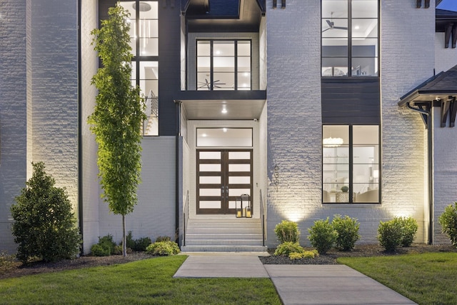 doorway to property with a yard