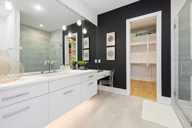 bathroom with vanity and a shower with shower door