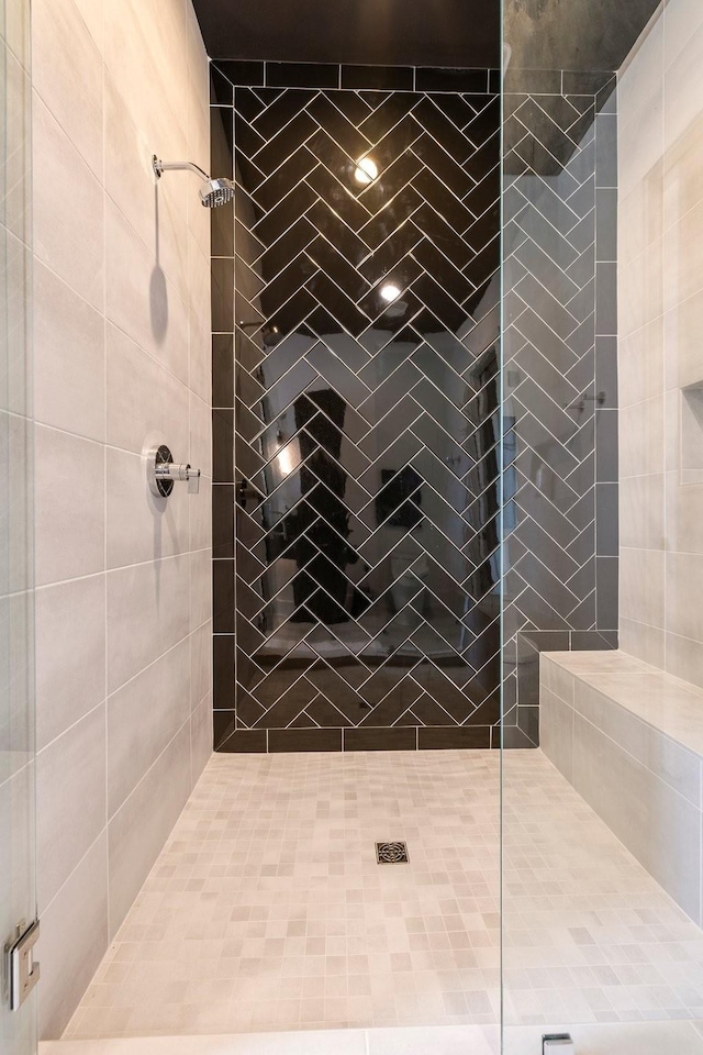 bathroom featuring a shower with door