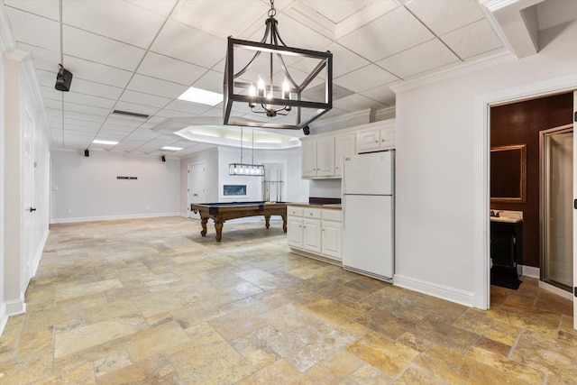 kitchen featuring a paneled ceiling, billiards, white cabinets, white refrigerator, and hanging light fixtures