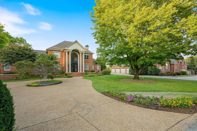 greek revival house featuring a front yard