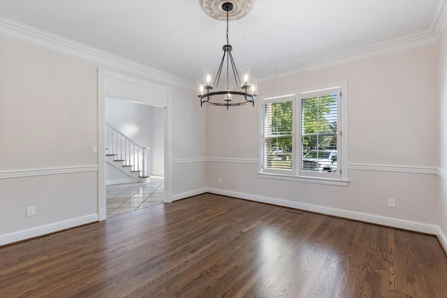 unfurnished dining area featuring an inviting chandelier, ornamental molding, and dark hardwood / wood-style floors