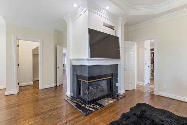 unfurnished living room with a tile fireplace, dark wood-type flooring, and ornamental molding