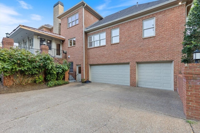 view of front of property featuring a garage and a balcony