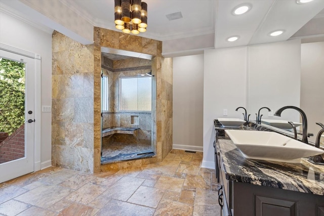 bathroom with ornamental molding, a chandelier, vanity, and a tile shower