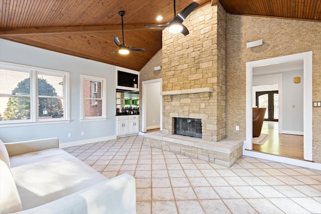 unfurnished living room featuring tile patterned floors, a stone fireplace, wooden ceiling, beamed ceiling, and ceiling fan