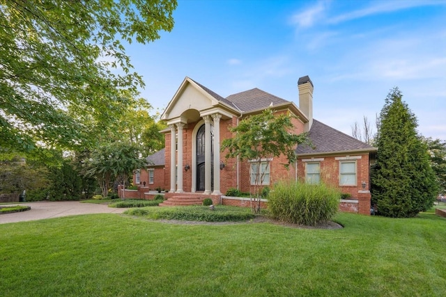 greek revival inspired property featuring a front yard