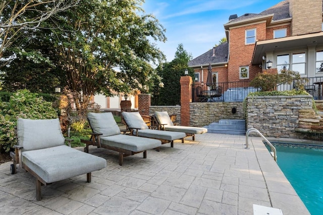 view of patio / terrace with a fenced in pool