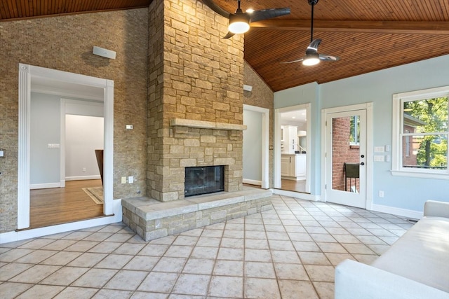 unfurnished living room with light tile patterned floors, wood ceiling, an outdoor stone fireplace, ceiling fan, and high vaulted ceiling