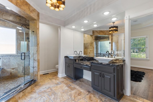 bathroom featuring a shower with door, ornamental molding, vanity, and toilet