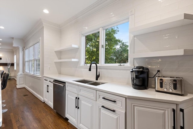 kitchen featuring decorative columns, tasteful backsplash, sink, stainless steel dishwasher, and crown molding