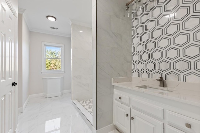 bathroom featuring crown molding, a tile shower, and vanity