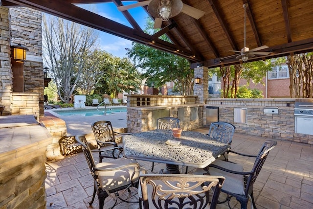 view of patio featuring area for grilling, a fenced in pool, a gazebo, and ceiling fan