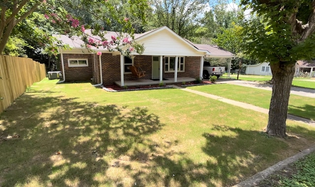 view of front of house featuring covered porch and a front lawn