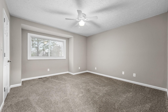 carpeted empty room with a textured ceiling and ceiling fan