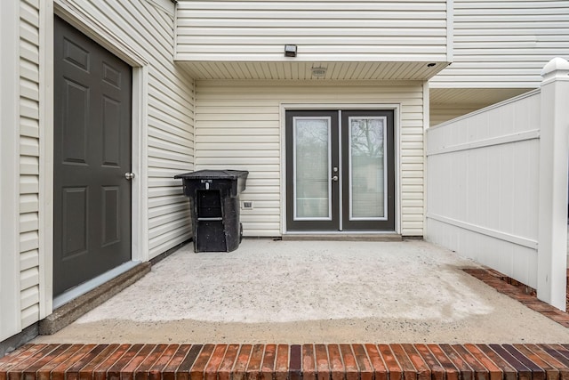 property entrance featuring a patio area and french doors