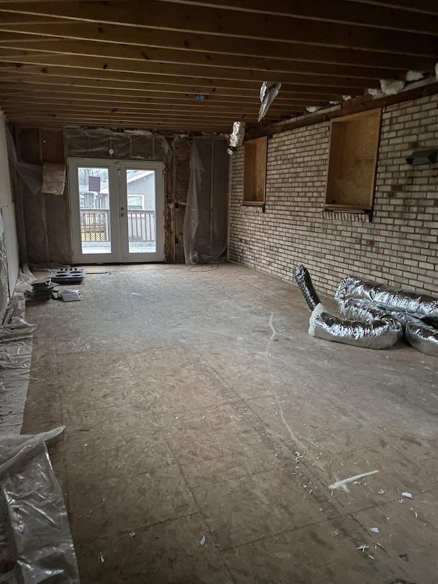 misc room with french doors and brick wall