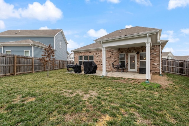 rear view of house featuring a patio and a yard