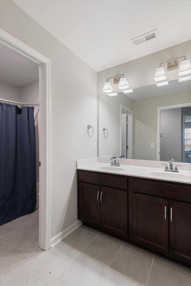 bathroom featuring vanity and tile patterned flooring