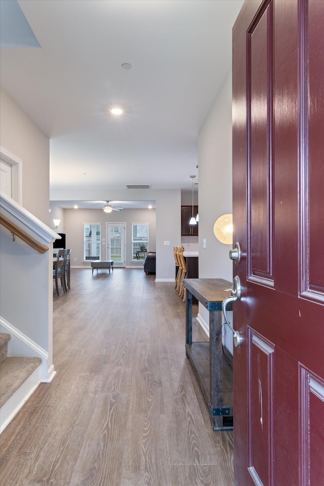 foyer featuring ceiling fan and light hardwood / wood-style flooring