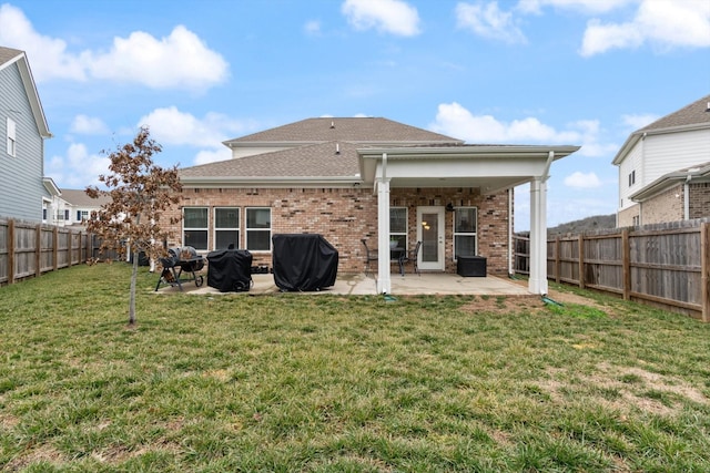 rear view of house featuring a patio and a lawn