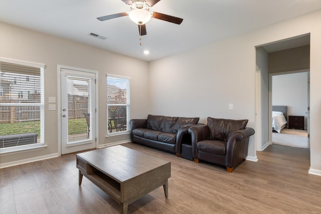 living room with ceiling fan and light hardwood / wood-style floors