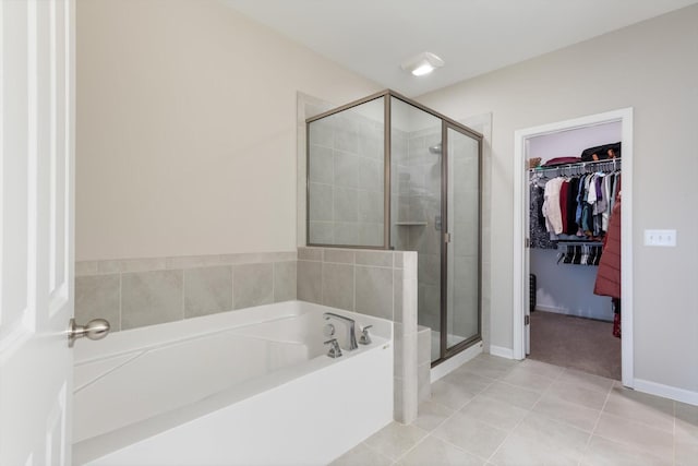 bathroom with tile patterned floors and shower with separate bathtub