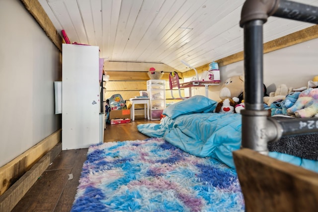 bedroom with vaulted ceiling, wooden ceiling, dark hardwood / wood-style floors, and wood walls