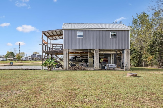 rear view of house featuring a yard