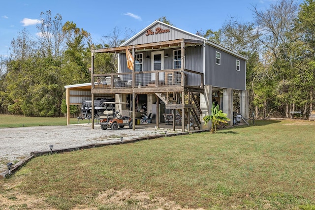 rear view of house featuring a yard, a carport, and a porch