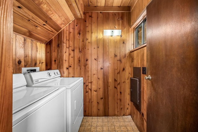 laundry room with wood ceiling, washing machine and dryer, and wood walls