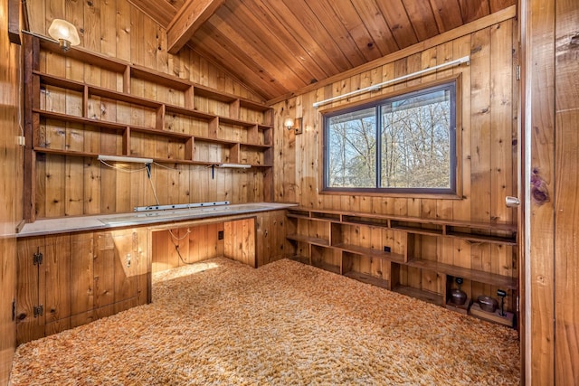 unfurnished office featuring wood ceiling, wooden walls, carpet floors, built in desk, and vaulted ceiling