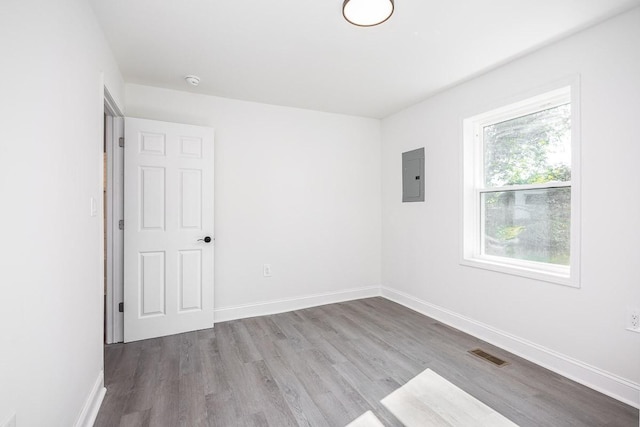 unfurnished room featuring light hardwood / wood-style flooring and electric panel