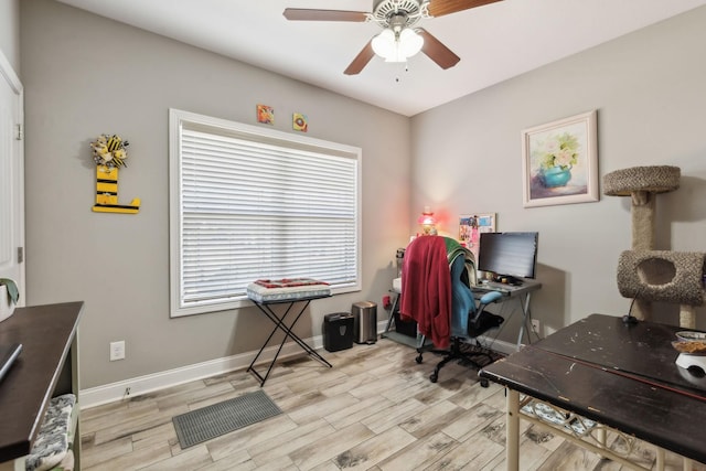 office with light hardwood / wood-style flooring and ceiling fan